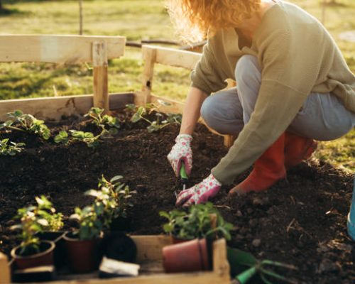close up of woman feeling relaxed gardening in her garden