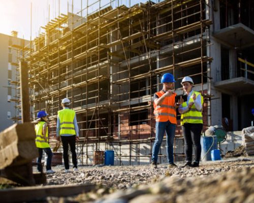 four construction workers having meeting